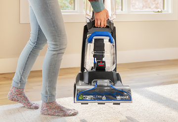 Lifting TurboClean Pet XL Carpet Cleaner to move.