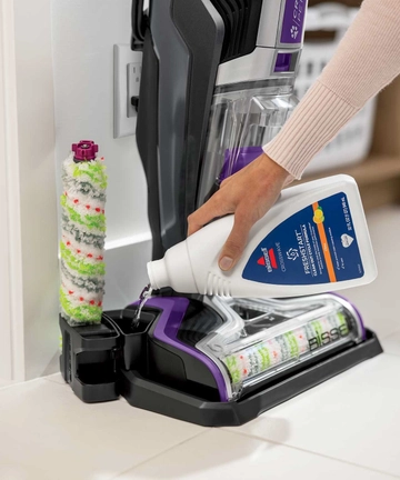 Pouring Self Cleanout formula into storage tray.