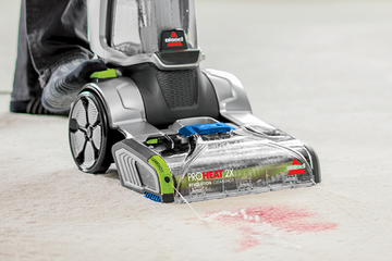 Using CleanShot Pretreater on foot to spray stain on carpet.