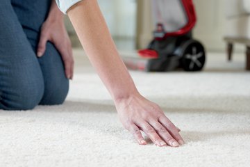 Running hand across carpet