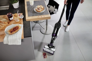 CrossWave Cordless Max Multi-Surface Wet Dry Vac vacuuming and mopping up spilled mess on tile floors.