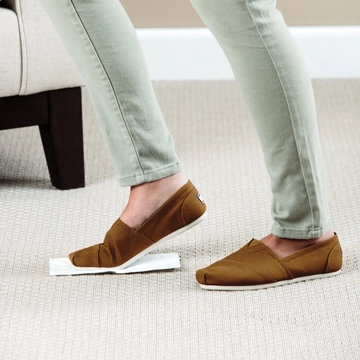 Stomp 'n Go® Pet Stain Lifting Pads being stomped into carpet.