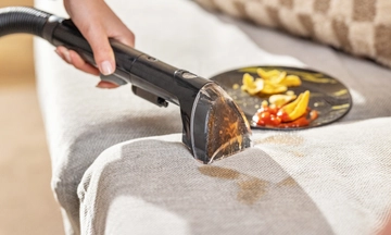 Using Tough Stain Tool to clean spill on couch cushion.