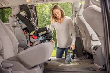 Using Pet Stain Eraser Plus Portable Cleaner to clean spill in car interior.