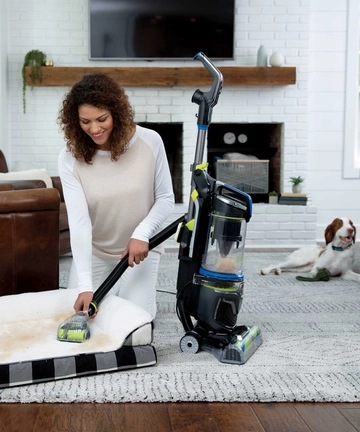 Using Pet TurboEraser Tool on end of hose to vacuum pet bed.