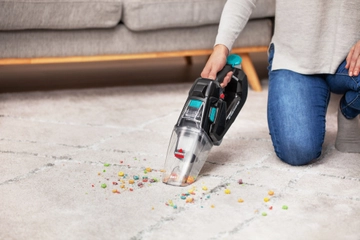 Pet Stain Eraser Dry Hand Vacuum attachment cleaning mess off area rug.