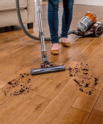 Hard Floor Expert Canister Vacuum Vacuuming dirt from hard flooring