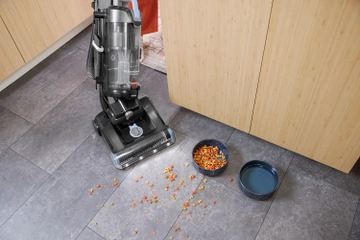 vacuuming dog food from kitchen flooring