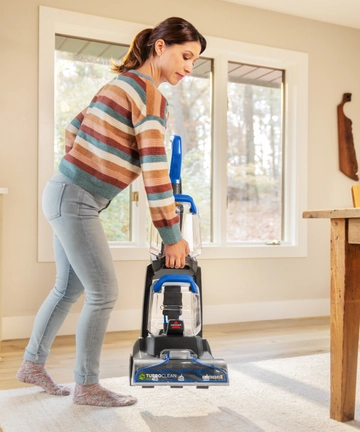 Lifting TurboClean Pet XL Carpet Cleaner to move.