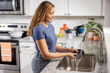 Washing Filter at sink.