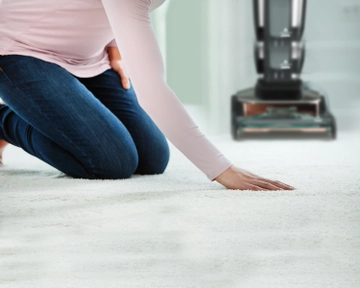 Running hand across dry carpet.